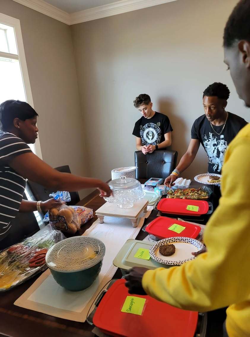 Family sharing a 4th of July celebration meal.